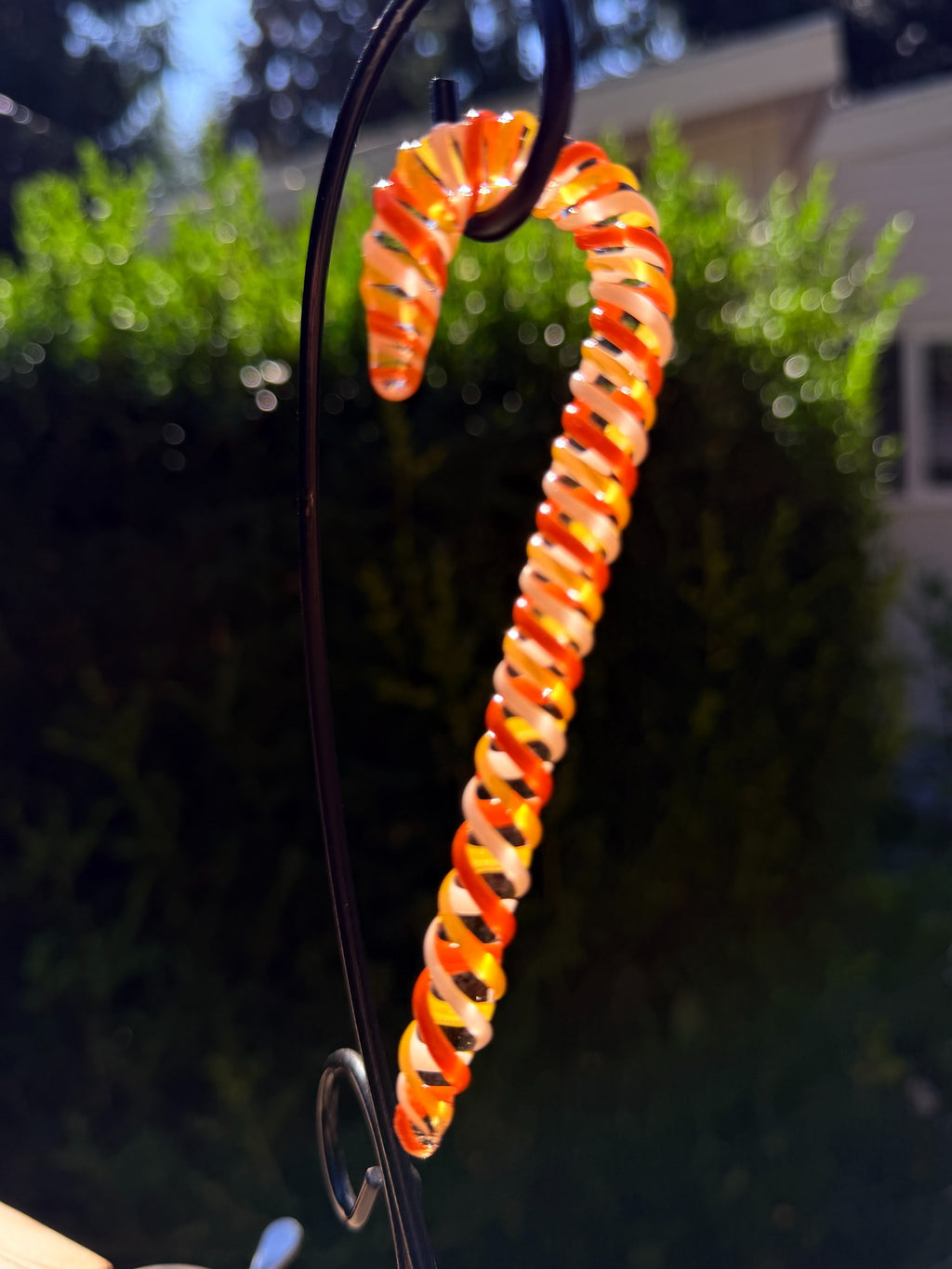 Handmade orange and white glass candy cane ornament