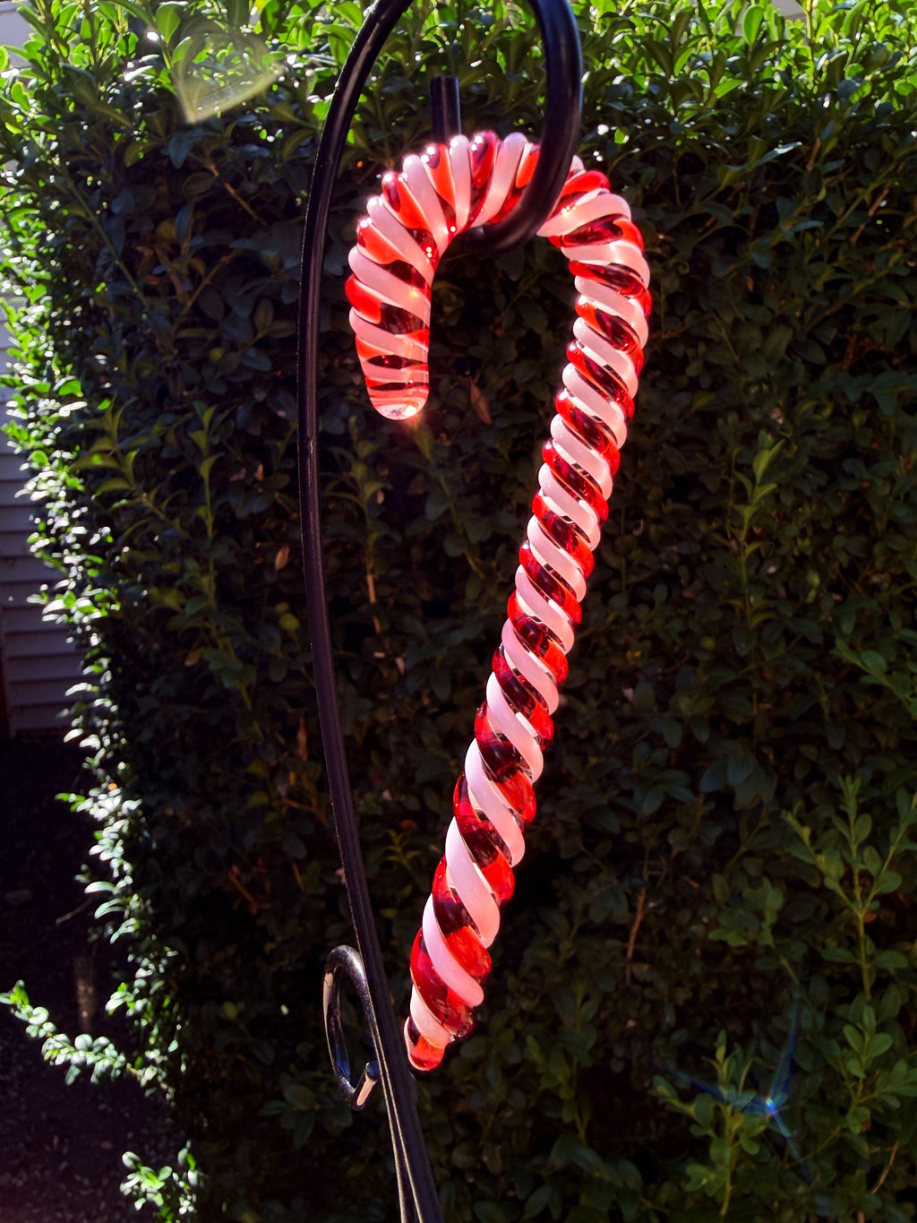 Handmade red and white glass candy cane ornament