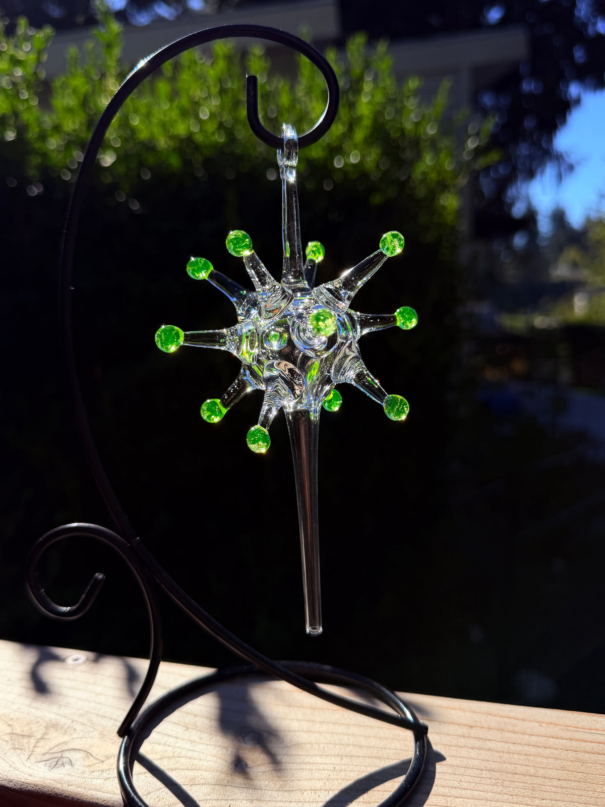 Uranium Atomic Starburst glass ornament in daylight