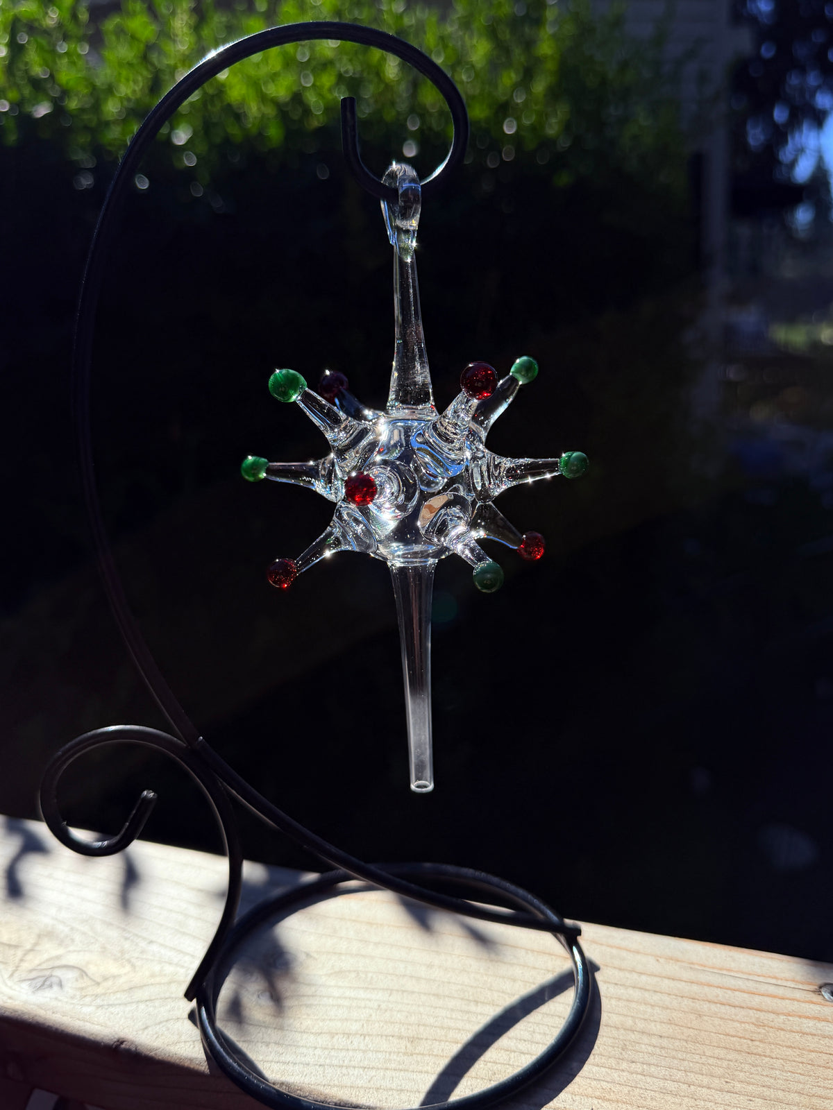 Starburst glass ornament with red and green color dots